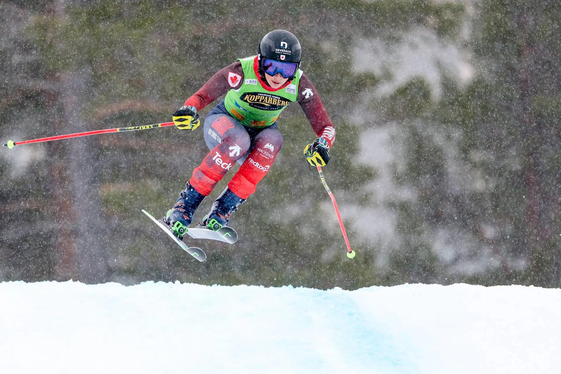 A skier in the snow jumps through the air in an action shot