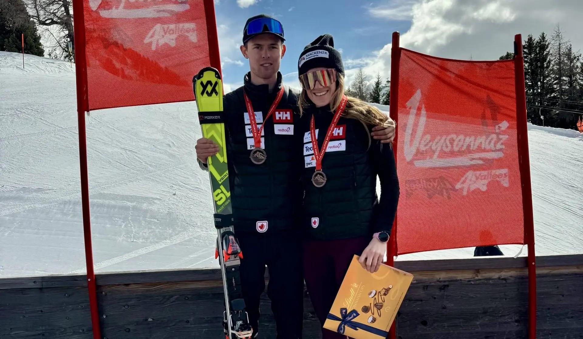Kalle Ericsson, and guide Sierra Smith, standing with their medals after placing third in the slalom in men vision impaired