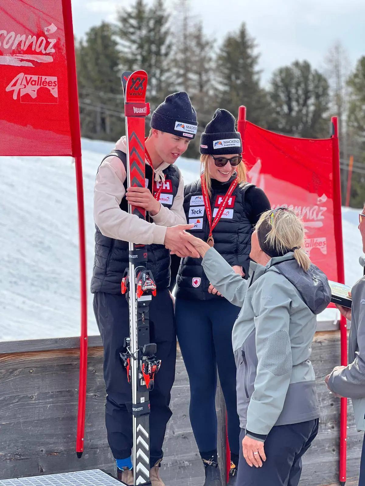 Kalle Ericsson on the winners' podium shaking hands with an official