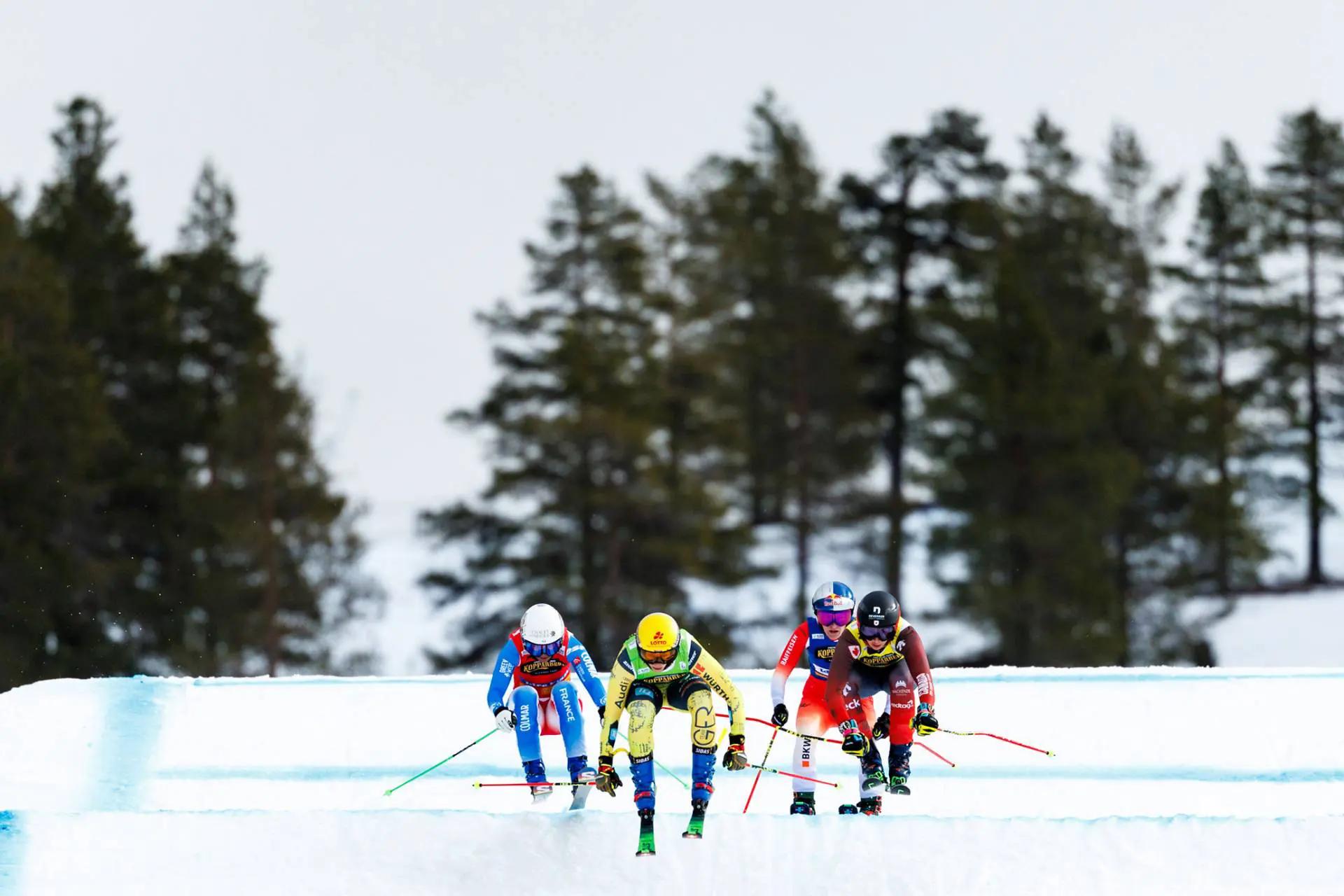 An action shot of 4 skiers
