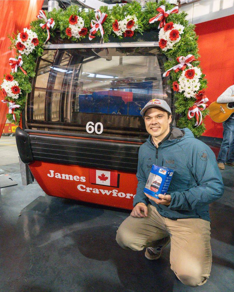Canada’s James Crawford poses in front of the gondola